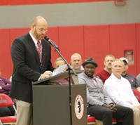 mister tomm speaks at podium