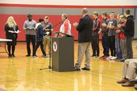 people clapping as student receives award