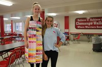 student next to student wearing dress made from paint chips