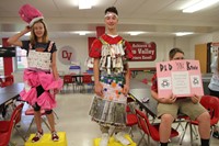students dressed for trashion show with garments made of recyclable items
