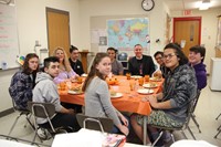 more students and staff sitting at table