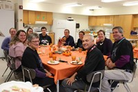 students and staff sitting at table