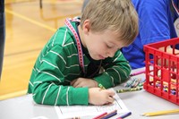 boy coloring at humanities night