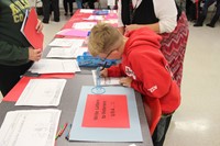 boy writing letter to veterans