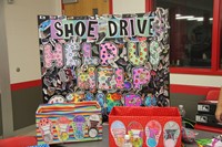 colorful sign that says shoe drive help us help others