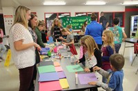 colorful table of glitter and glue creations