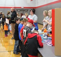 kids coloring at table at humanities night