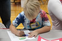 boy coloring in picture