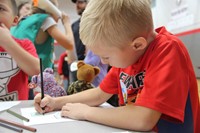 boy coloring picture of veteran at humanities night