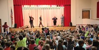 students raise hands to ask questions at chenango bridge fire safety assembly