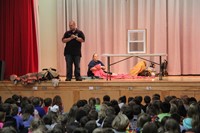 firefighters perform a fire safety demonstration involving a window