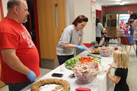 staff helping to serve food at humanities night