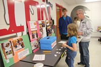 student and parent at tablet to vote for best grilled cheese flavor