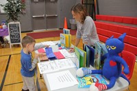 student choosing a card at humanities night activity