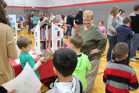 students getting books from the little free library