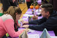 students working with teacher at musical table at humanities night