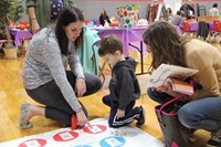 teacher explaining activity to boy at humanities night