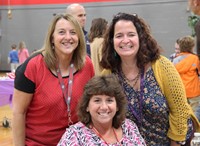 three c v staff members at humanities night