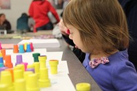 young girl playing with stamps