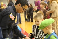 high school student helping younger students with game