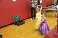 little girls dressed as princesses playing game