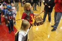 student dressed as campfire and smores parade around gym