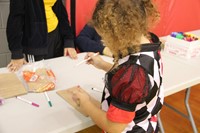 girl drawing on paper bag