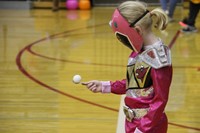 girl dressed as pink power ranger playing game