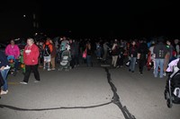 wide shot of people outside for trunk or treat event