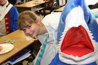 student next to another student dressed as a shark