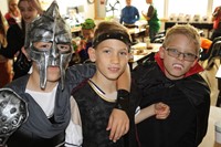 three boy students dressed in halloween costumes
