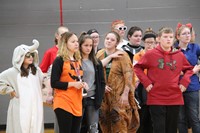 students and teacher dressed up for middle school costume contest