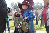 student dressed as cowboy riding dinosaur