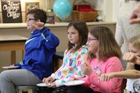 closer shot of students holding thumbs up or down about cheese