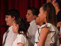 students singing on stage up close