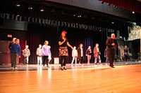 students learn salsa dancing