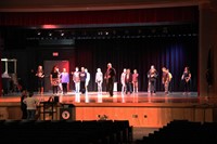 far shot of students learning salsa dancing