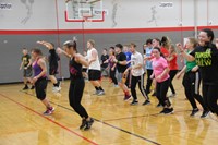 wide shot of students zumba dancing