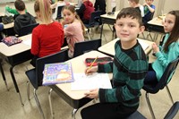 student smiling with book