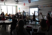 students raise hands to answer question