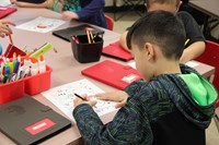 student filling in coloring sheet