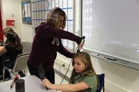 teacher curling students hair