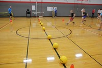 students running towards dodgeballs