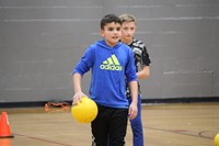 student holding dodgeball