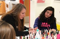 teacher painting students nails