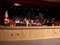 far shot of band playing with snow falling