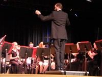 man conducting band