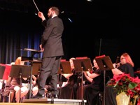 man conducting band at concert