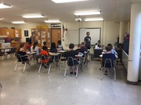 classroom shot of summer steam students from grades 4 and 5 working on sprout houses from back of cl