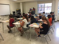 classroom shot of summer steam students from grades 4 and 5 working on sprout houses